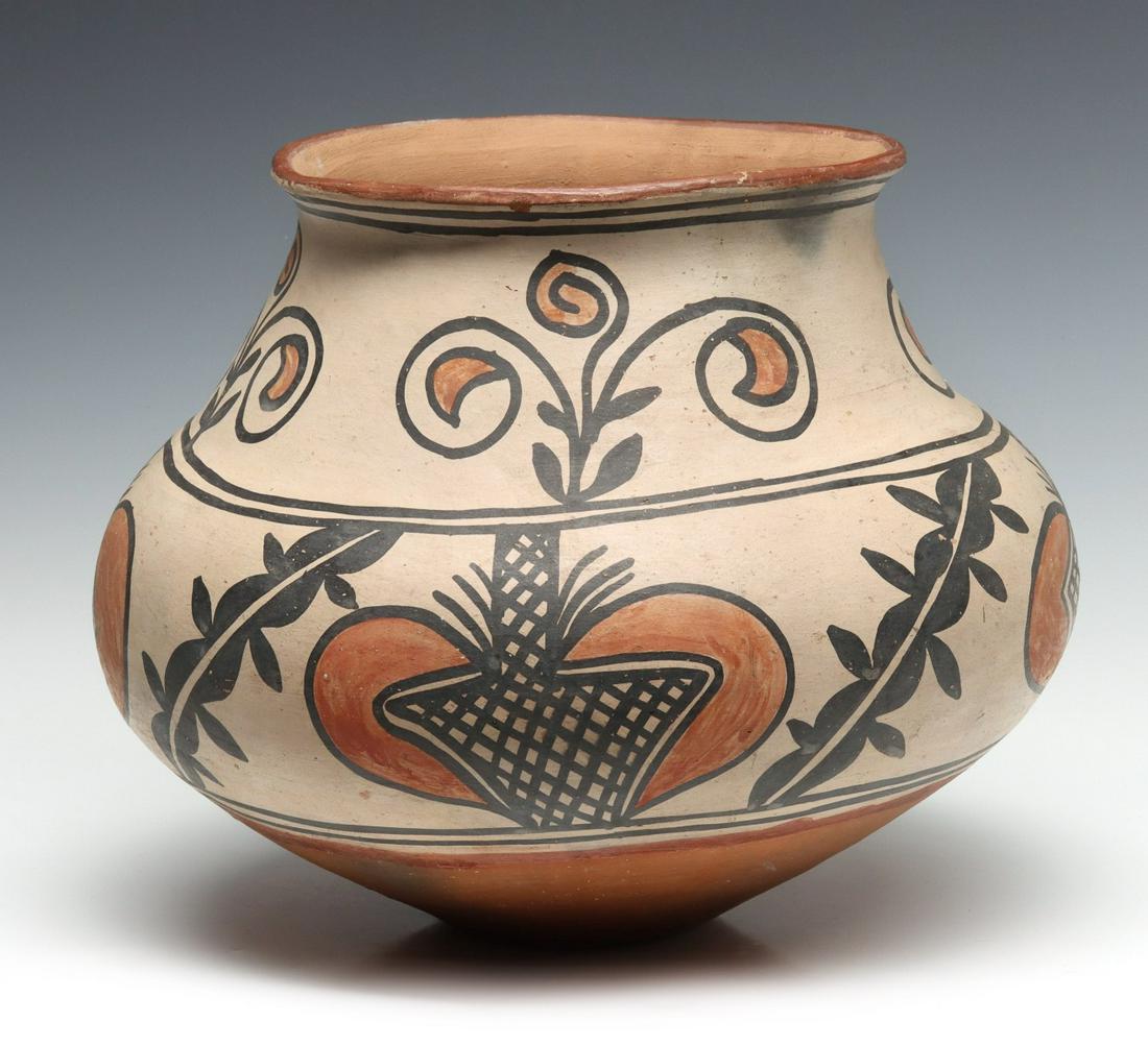 A NICE LARGE 19TH C. SAN ILDEFONSO PUEBLO POTTERY JAR: 1890 - 1900 The slightly rolled top rim over a somewhat concave neck with black and red foliate designs on buff slip blending into the pronounced swollen middle body with hearts and dividers in red an