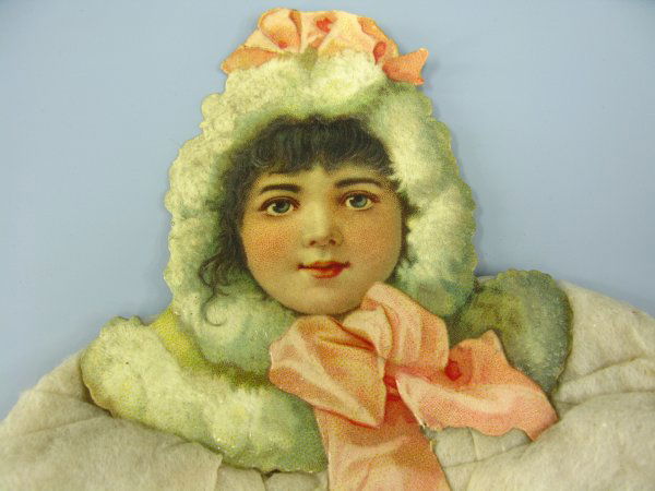 VICTORIAN DIE CUT DRESDEN GIRL WITH COTTON COAT: Measures 13 x 8 inches, die cut head, hand warmer, boots, fluffy white cotton 'coat.'