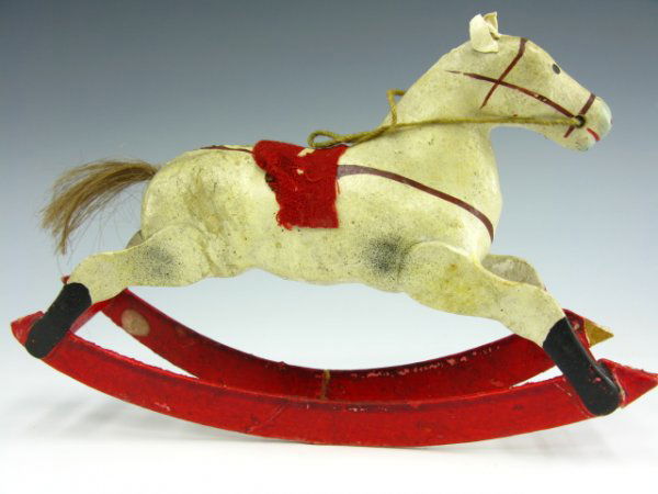 EARLY 1900'S GERMAN PAPIER MACHE ROCKING HORSE: Measures 4.5 x 7 x 2 inches. Paper mache body with cloth saddle, appears to have genuine hair tail. Wooden rockers spaced by thread spool.