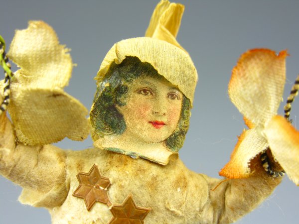 COTTON & CHROMOLITHO GIRL CHRISTMAS ORNAMENT: Measures 5 inches, chromolitho face, wire jump rope with applied blossom.