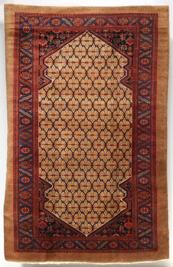 AN ANTIQUE NORTHWEST PERSIAN KURDISH RUG: The double niche field perfectly fitted with a central honeycomb trellis within 'spandrels' of dark blue ground and framed by a border of flower heads and leaves surrounded by open camel-colored groun