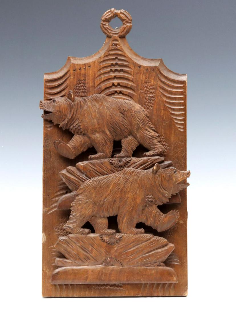 AN UNUSUAL EARLY 20TH C BLACK FOREST CARVED WALL RACK: The rustic back plate with carved top ring for hanging, two horizontally hinged carved silhouette figural bears that fold outward to serve as a holder for letters, photos or other flat objects. Measur