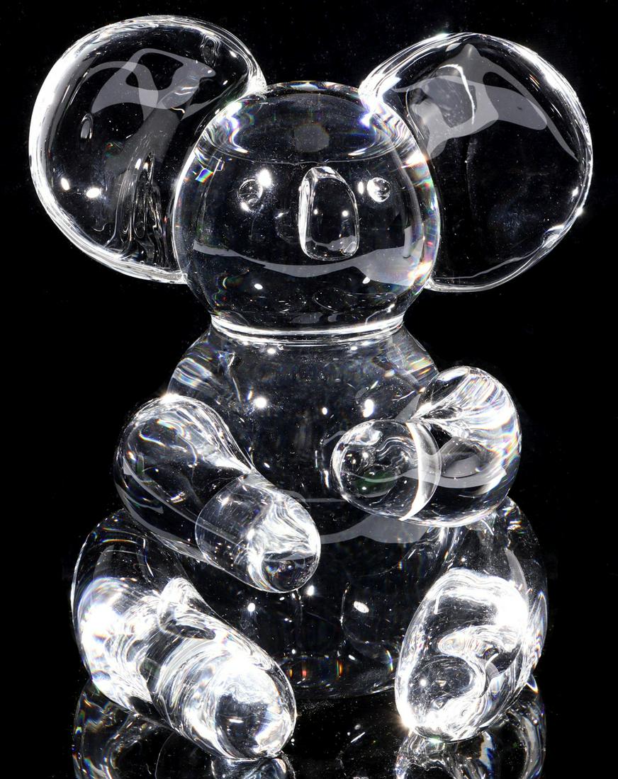 A STEUBEN ART GLASS CRYSTAL KOALA BEAR FIGURE: Circa 1971 The Steuben crystal figure by designer Lloyd Atkins with engraved Steuben signature underside of the base. Measures 6 x 5 x 4 inches. Provenance: The Topeka and Shawnee County Public Librar