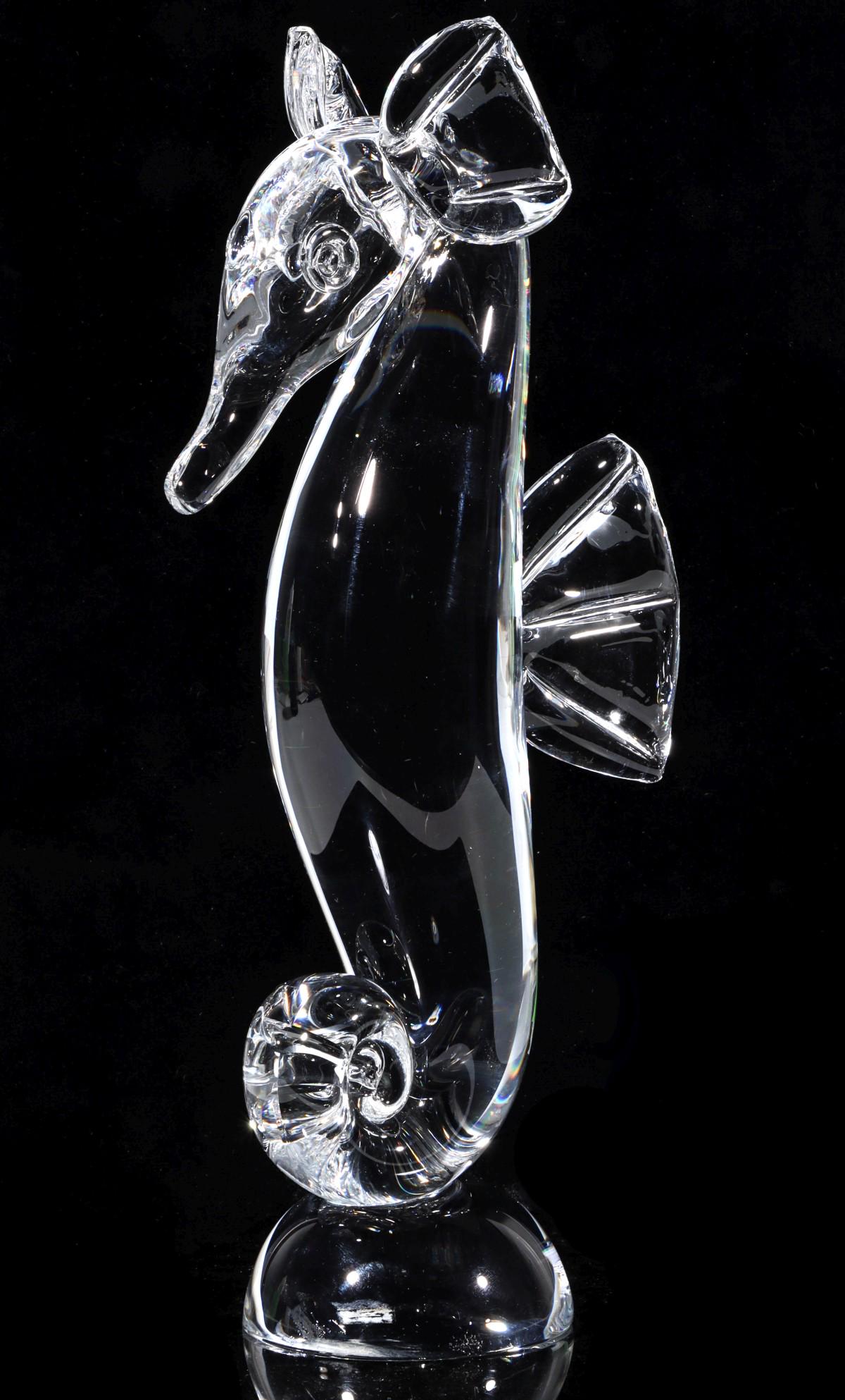 A STEUBEN ART GLASS CRYSTAL SEAHORSE: Circa 1961 The figure of a seahorse by Steuben designer Lloyd Adkins, engraved signature on the base. Measures 10 x 5 inches. Provenance: The Topeka and Shawnee County Public Library We happily provid