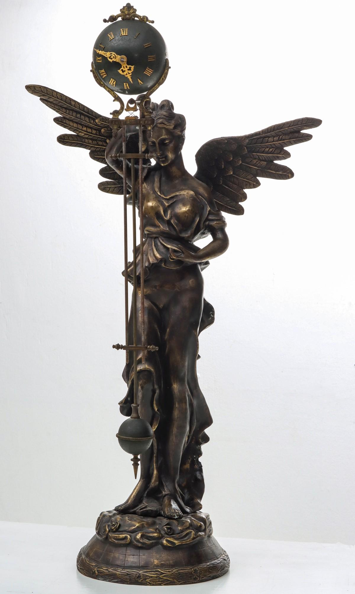 A REPRO BRONZE WINGED FIGURE WITH SEFIA MYSTERY CLOCK (1 of 13)