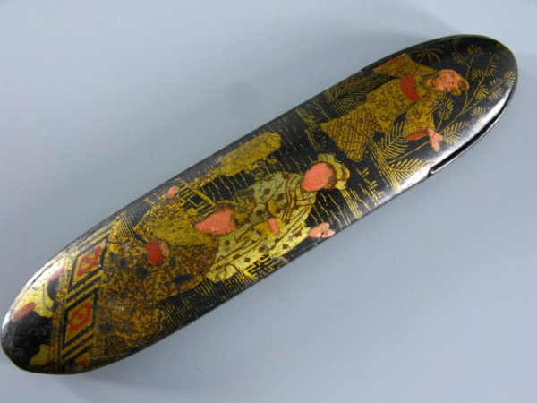 LACQUERED AND PAINTED WOOD ORIENTAL GLASSES CASE: Hinged access door, gilt painted detail, includes pair of wire rimmed spectacles. 6 1/2 x 1 1/2" overall.