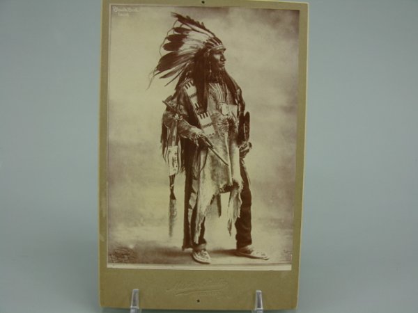 SIOUX CHIEF BLACK BIRD CABINET PHOTO 1890'S: Standing side image of Black Bird on Mistic Studio cabinet photo stock. Period reprint with alterations to lower left and right corners. Handwritten "Black Crow, Sioux Chief" to back. Image size 5.5 x
