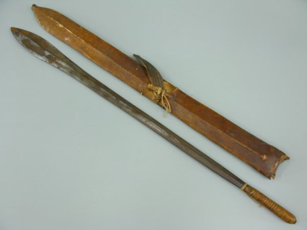 TRIBAL YORUBA SHORT SWORD & SHEATH: Measures 27 inches overall. Dual-edged, narrow to wide blade, old leather grip. Includes leather sheath with broken belt.