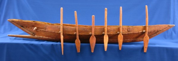 LAKE VICTORIA-AREA TRIBAL WAR SHIP MODEL: Measures about 8 x 15 (at oars) x 64 inches. Superb red wood model with oars stowed vertically along the length. Ram to stem, log seats. Very nice hand carved and constructed model. Circa 1900-1920. C