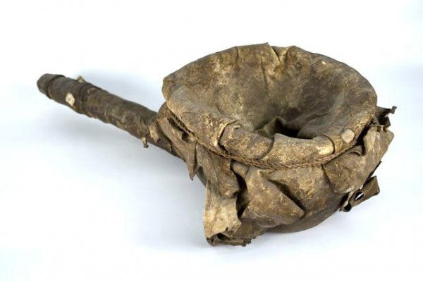 AFRICAN BLACKSMITH BELLOWS CIRCA 1920'S: 8 x 29 x 11 inches, kettle shaped bowl with rawhide diaphram stretched over the top and held in place with grass cord. Museum accessions report states it was collected by Quaker missionaries during th