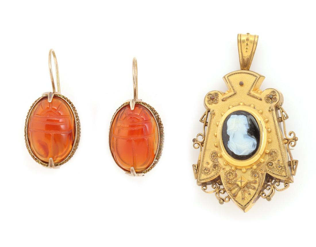 VICTORIAN ETRUSCAN WORK LOCKET AND FRENCH WIRE EARRINGS: The shield motif gold-filled locket with Etruscan work and carved hardstone cameo offered here with a pair of French wire earrings set with carved carnelian scarabs marked 925. Locket measures 2.25 x 