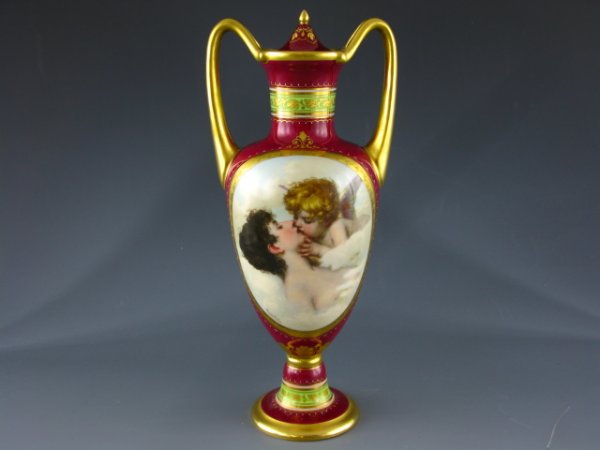 19TH C. ROYAL VIENNA BOLTED URN WITH COVER: Stands 10.5 inches. Polychrome scene of a cherub kissing a woman, underglazed beehive to bottom. Includes lid. Artist signed 'Kroullez.' poor restoration at bolt area