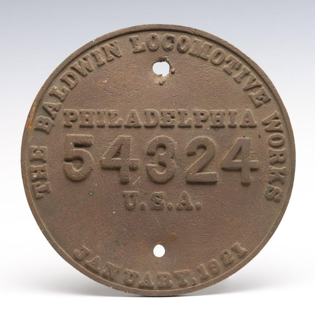 A BALDWIN BUILDER'S PLATE FOR T&NO RR SWITCHER 144: The circular brass plate with embossed letters and raised outer rim from Texas and New Orleans railroad steam switcher locomotive number 144. Measures 9.25 x 0.5 inches. We happily provide seamless in