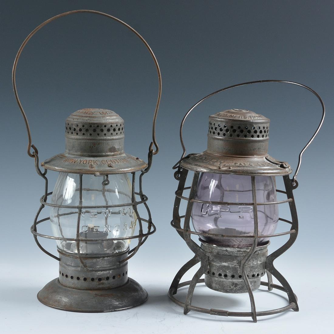 N.Y.C. AND C.P.R. TALL GLOBE RAILROAD LANTERNS: The Dietz lantern marked NEW YORK CENTRAL on the shoulder, with a tall clear globe cast NEW YORK CENTRAL. Plus an E.T. Wright lantern marked C.P.Ry. on the shoulder for Canadian Pacific Railway, tall 