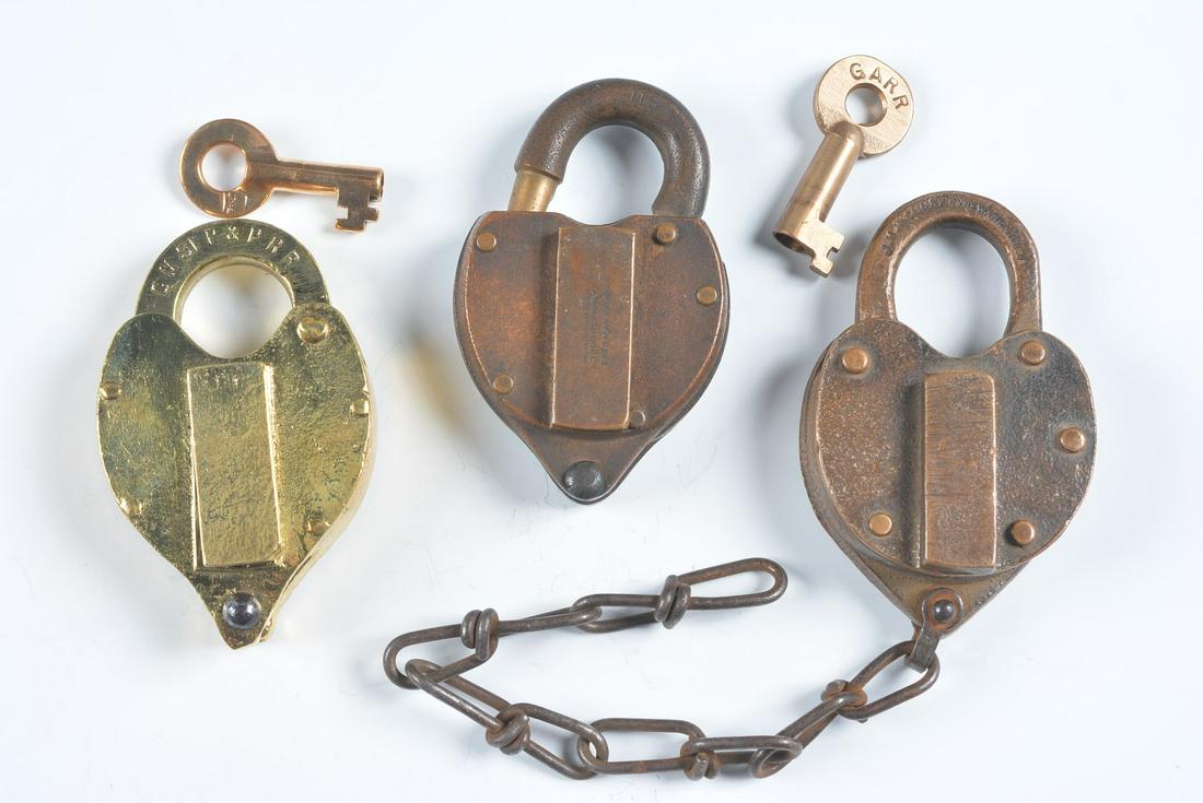A COLLECTION OF PADLOCKS WITH RAILROAD MARKINGS: Three padlocks include: A brass lock stamped CMStP&PRR on the shackle for the Chicago, Milwaukee, St. Paul and Pacific Railroad, swivel dust guard, stamped Hansl. Mfg. Co. maker's mark, includes key; 