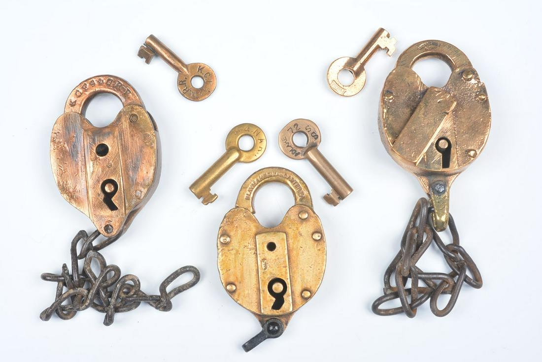 CAST BRASS PADLOCKS WITH RAILROAD MARKINGS: Six railroad padlocks include: An Adlake lock stamped D&RGRY on the shackle for the Denver & Rio Grande Railway, no key; An unsigned lock with raised lettering L&N.R.R. on the body for Louisville & Na