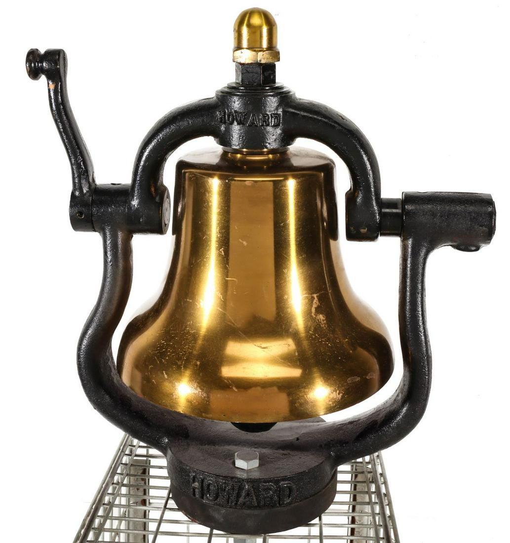 A HOWARD 12-INCH LOCOMOTIVE BELL WITH RED INTERIOR: The polished and lacquered bronze bell with red interior, the cast iron yoke with cast letters of HOWARD on the yoke's top and base, cast numerals 1021, the name GRAHAM-WHITE on the clapper. Measures