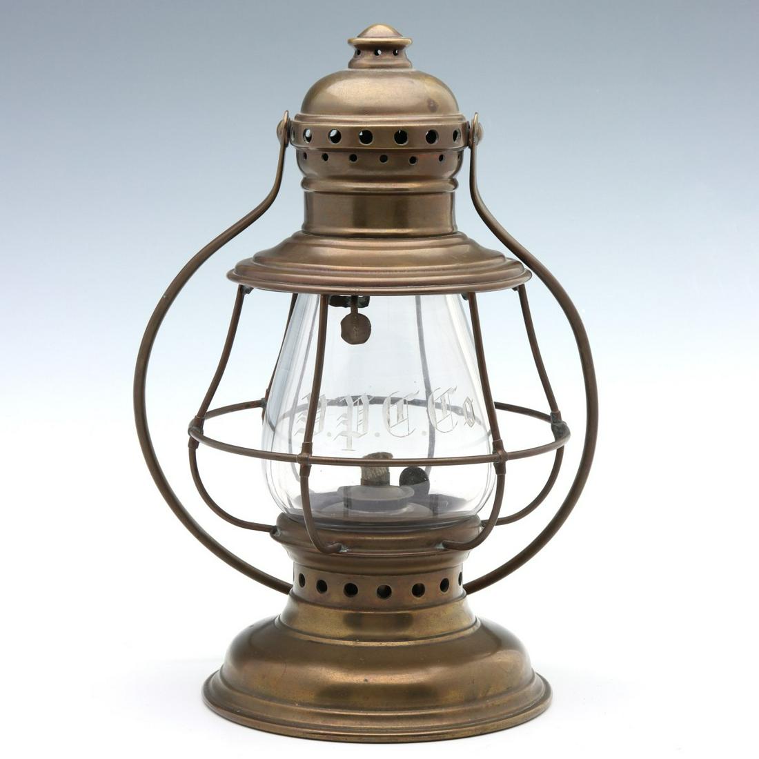 A PULLMAN PALACE CAR CO ENGRAVED PRESENTATION LANTERN: The brass frame with tall extended lip globe engraved by hand as P.P.C.Co. in Old English script, swing handle, the base with stamped mark of CT HAMM, the wick turner marked THE P&A MFG CO. We happily