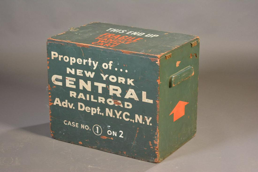 A SHIPPING CRATE FOR NEW YORK CENTRAL RR ADV. DEPT: The plywood box with hinged lid painted green and lettered Property of .NEW YORK CENTRAL RAILROAD ADV. DEPT., N.Y.C., N.Y. on two sides. Measures 20 x 24 x 16.5 inches. We happily provide seamless in-