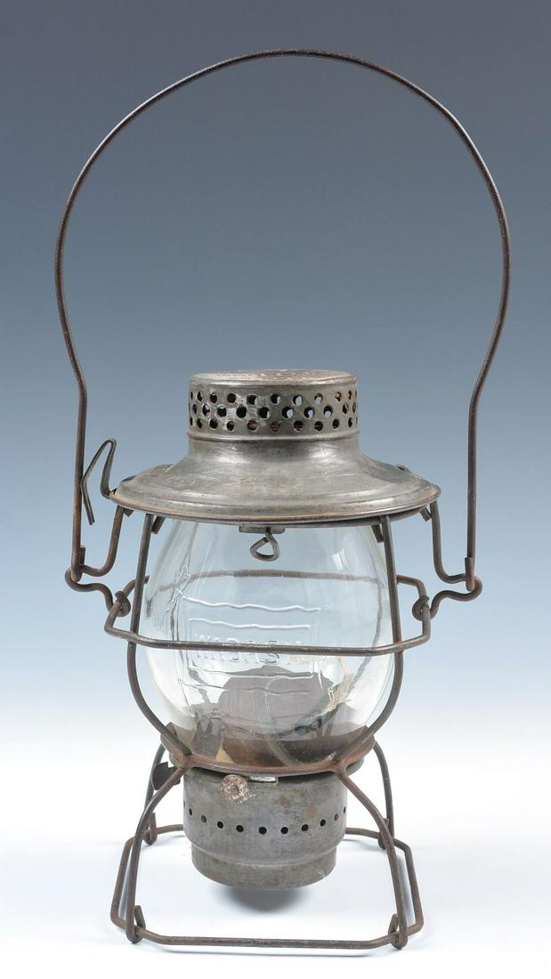 A WABASH RAILROAD LANTERN WITH CAST LOGO ON GLOBE: The wire frame Handlan lantern marked WABASH on the shoulder, tall clear globe cast with Wabash flag logo. We happily provide seamless in-house packing and shipping services on nearly everything we se