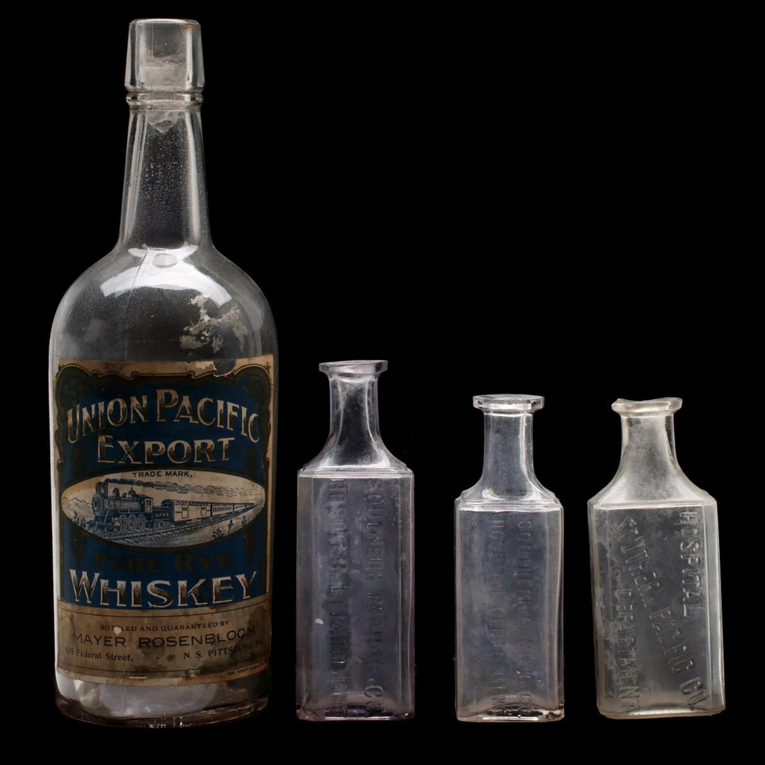 UNION PACIFIC WHISKEY BOTTLE WITH LABEL, SP RR MEDICINE: Four 'medicine' bottles, one being a pre-prohibition quart whiskey bottle with its original paper label stating the product was bottled and guaranteed by Mayer Rosenbloom Pittsburgh. Plus three earlie