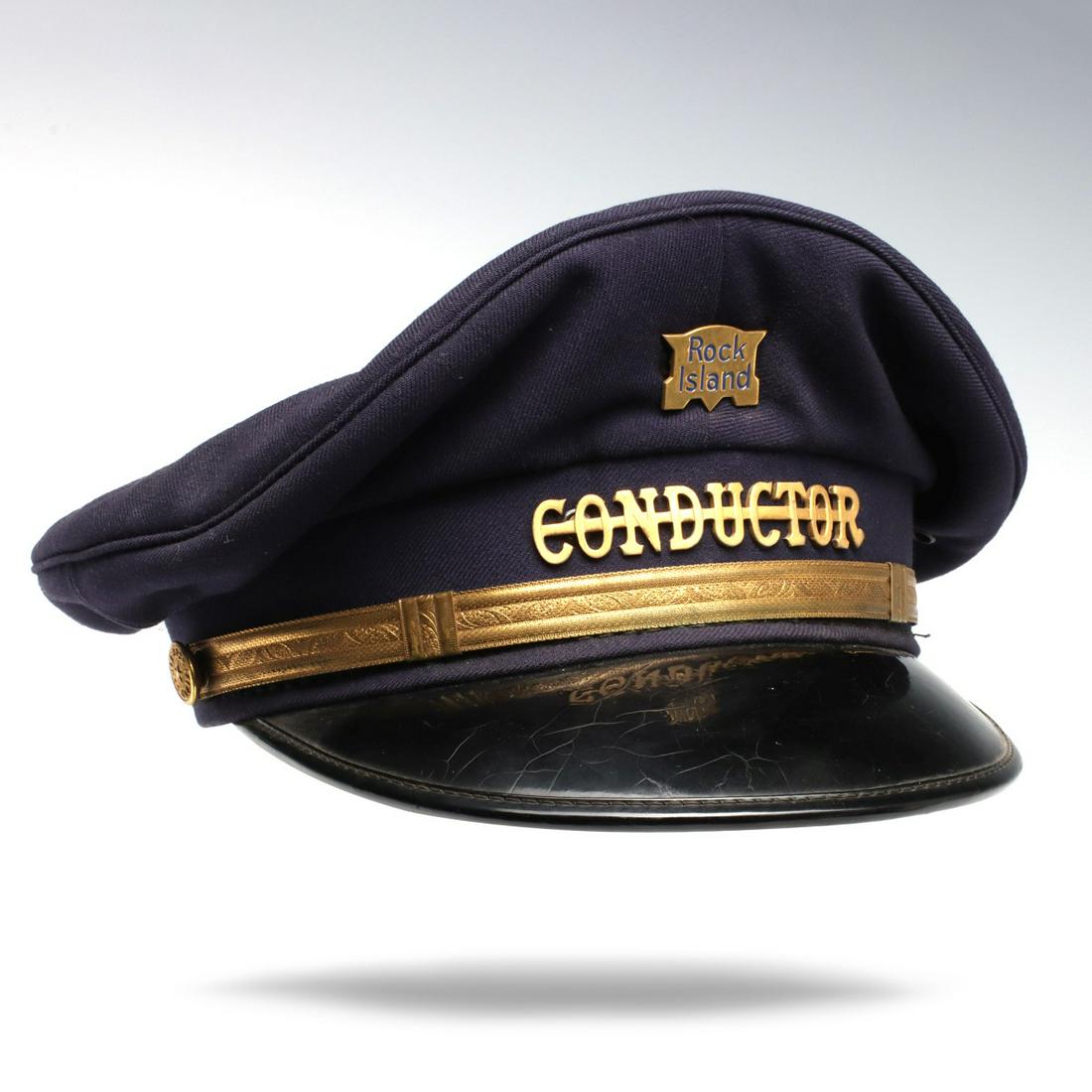 ROCK ISLAND RAILROAD CONDUCTOR'S VISOR CAP: The blue cap with patent leather visor, ROCK ISLAND badge, gold band and Rock Island buttons. Measures 5.5 x 9.5 x 11.5 inches. We happily provide seamless in-house packing and shipping services on ne