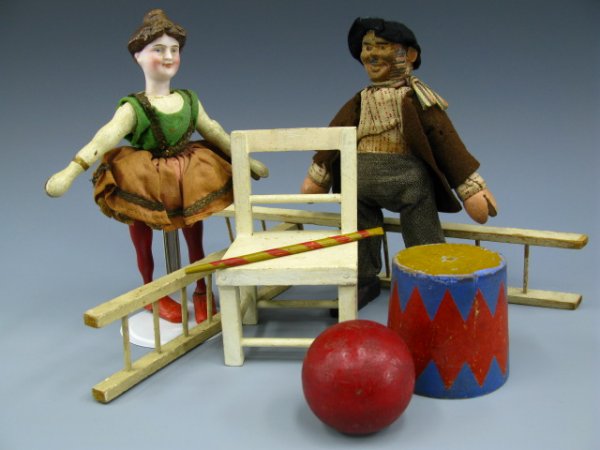 LOT OF SCHOENHUT CIRCUS FIGURES: Includes the 8 inch acrobat lady circus rider with bisque head, green felt top and cotton skirt, painted hair and facial features, red legs and large feet, hanging ring in back of head. Also a 7.75 in