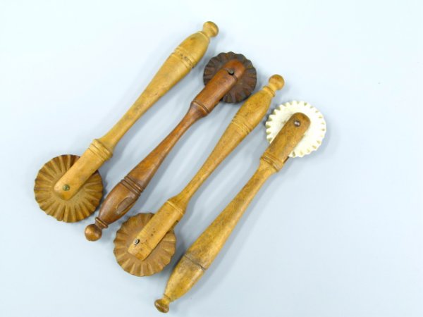 FOUR ANTIQUE WOODEN PIE CRIMPERS: All approximately 5 inches in length, one with bisque crimper.