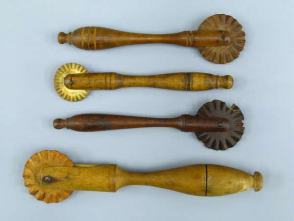 FOUR ANTIQUE WOODEN PIE CRIMPERS: Largest measures 6.25 inches, smallest with carved bone crimper.