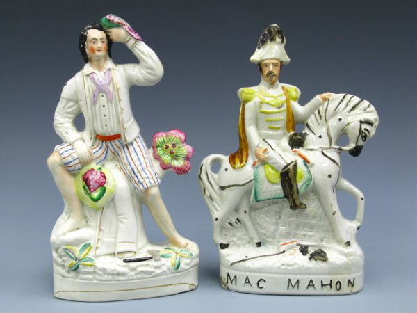 TWO STAFFORDSHIRE FIGURES: MAC MAHON resembles Napoleon III and measures 12.5 x 8 x 2.5 inches overall, handpainted details, other of a boy in white, hatchet at his feet and parrot in his hand, measures 13 x 7 x 2.5 inches over