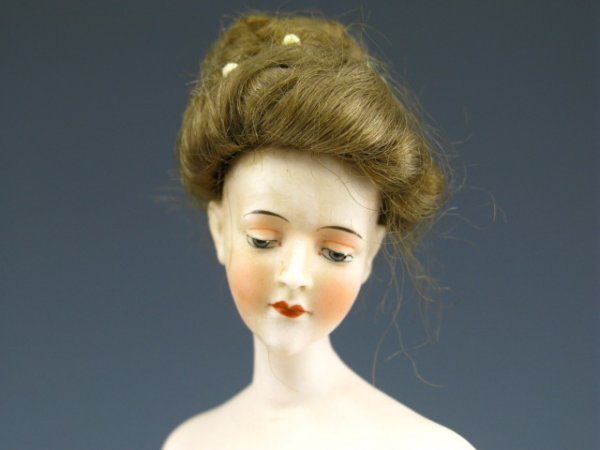 RARE GERMAN BISQUE BATHING BEAUTY W/REAL HAIR: Circa 1900 bathing beauty stands 11.5 inches tall, in white with light blue stockings and brown shoes, genuine dark blonde human hair on her head with 7 pins holding it in place, finely detail painted