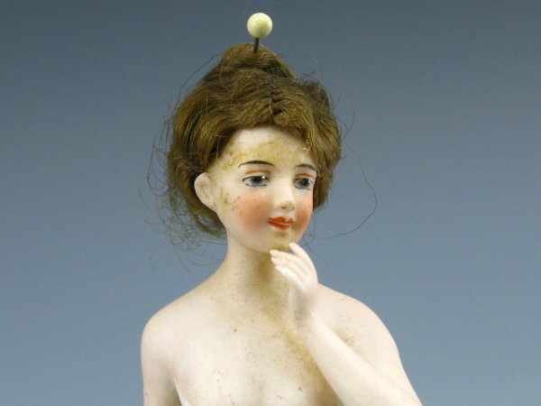 RARE GERMAN BATHING BEAUTY W/REAL HAIR: Circa late 1800s, bathing beauty stands 5 inches tall, in light blue pantaloons with pink stockings and shoes, genuine dark blonde human hair on her head with pin holding it in place, finely detail pa