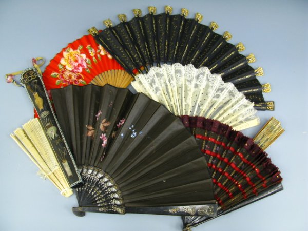 SEVEN ANTIQUE HAND FANS AND SHEATH: Includes two in white silk with sequins, one in black cotton with sequins, one brown oilcloth with beautifully painted floral theme, a mesh, and a couple in brittle paper, lot also includes a speciall