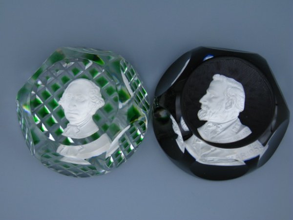 TWO BACCARAT SULPHIDE PAPERWEIGHTS: Both measures approximately 2.75 inches, George Washington image features clear glass with pyramid cut base with green tips, and a flat-bottomed burgundy tinted weight with Robert E. Lee image.