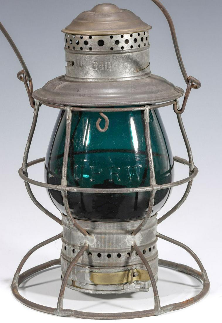 A RARE LANTERN W/TALL SIGNAL GREEN GLOBE CAST U P R W: The brass top wire frame Adams & Westlake lantern stamped u(?) 640 Q(?) on the smoke dome and having adjustable baffle to accommodate minor variations in globe size, embossed railroad marking of U. P.