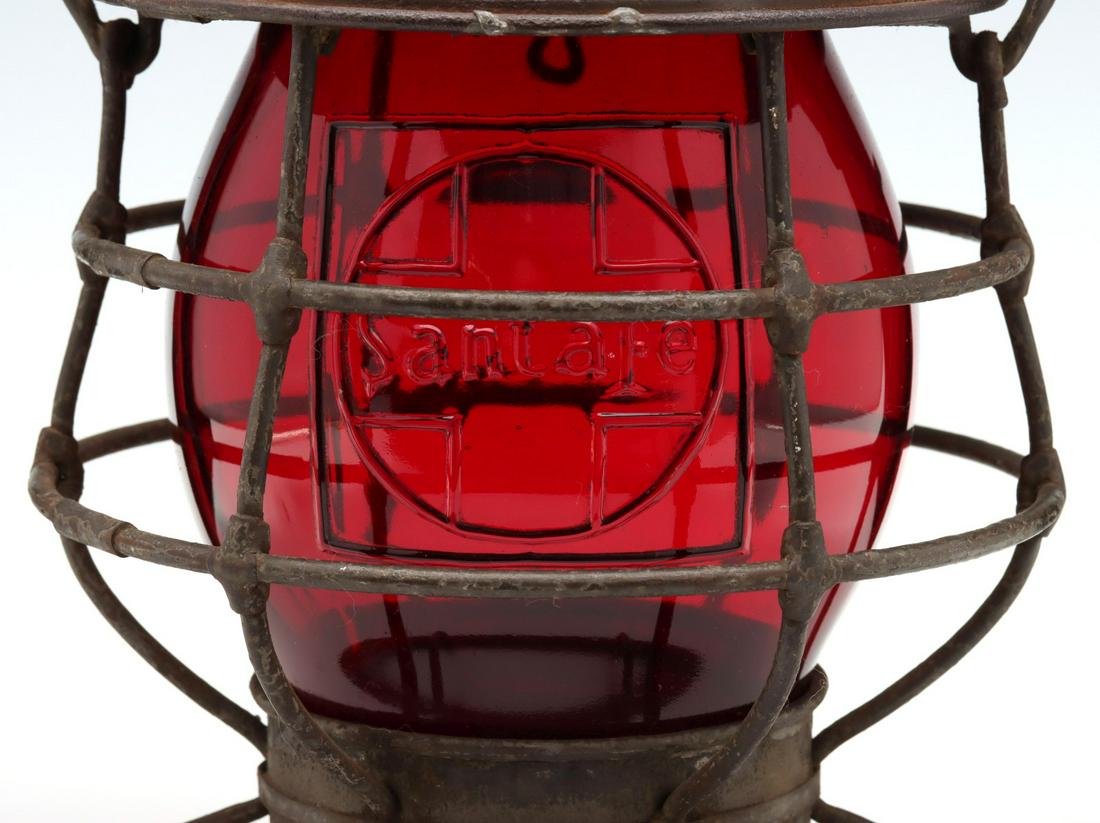 SANTA FE LANTERN WITH TALL CAST RED EMBOSSED LOGO GLOBE: The wire frame with embossed maker's mark of THE ADAMS AND WESTLAKE COMPANY CHICAGO NEW YORK on the cap and embossed railroad marking of SANTA FE on the shoulder with an additional ''A'' character emb