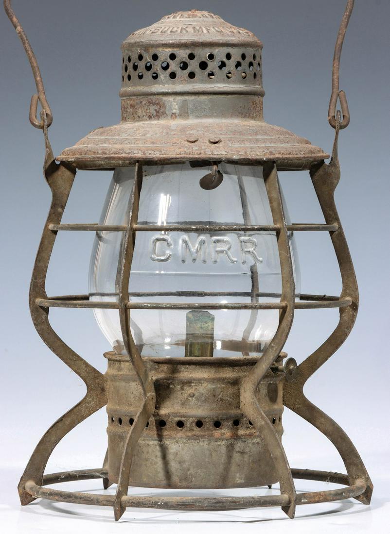 A TALL GLOBE RAILROAD LANTERN MARKED COLO. MID R.R.: The wire frame with flat verticals and embossed maker's mark of ''The HANDLAN'' HANDLAN BUCK MFG CO. St. Louis and embossed railroad marking of COLO. MID R.R. on the shoulder, tall extended lip glass