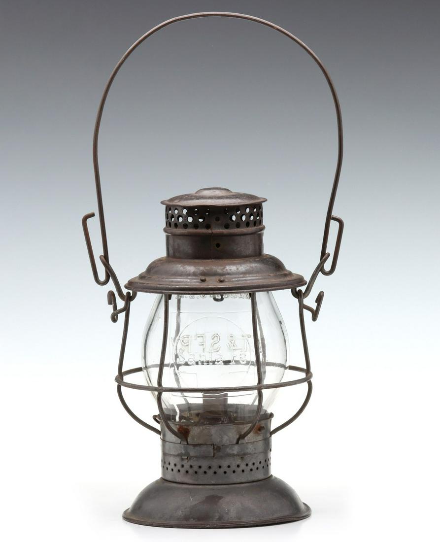 A DOUBLE CAST TALL GLOBE SANTA FE RAILROAD LANTERN: The unusual, double-marked, tall extended lip Corning glass globe with cast lettering of A.T. & S.F. RY. in high relief below the maker's mark on one side, and the opposite side embossed with lett