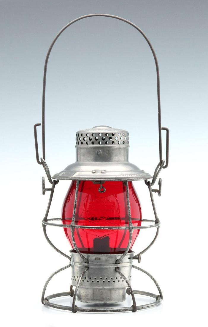 TALL LANTERN WITH CAST OVERLAND ROUTE LOGO ON RED GLOBE: The wire frame with embossed maker's mark of ''The ADAMS & WESTLAKE CO ''ADLAKE'' RELIABLE NEW YORK CHICAGO PHILA and embossed railroad marking of UNION PACIFIC on the shoulder, tall red glass globe w