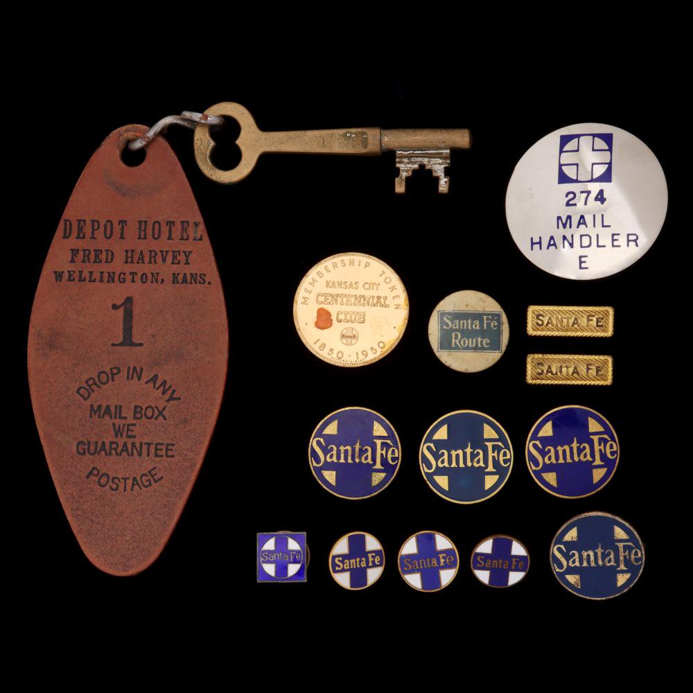 SANTA FE RAILROAD ENAMELED PINS AND FRED HARVEY KEY: The twelve pins and other items include: Three round enamel lapel pins with screw backs, two are signed O.C. Tanner Co.; A square enamel lapel pin with a screw back and marked Sterling; Four 1-inch en