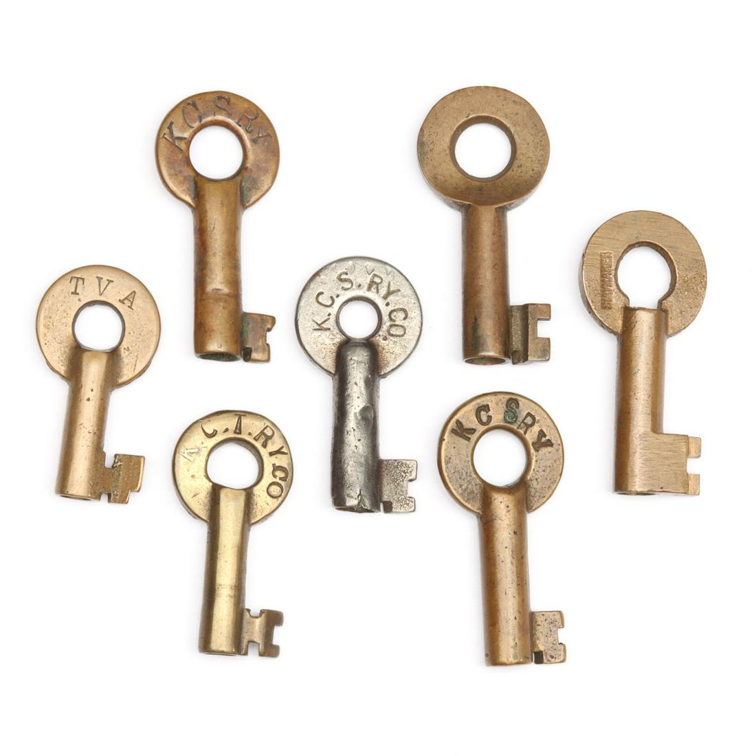 A COLLECTION OF MISSOURI AND OTHER RAILROAD SWITCH KEYS: The seven switch keys with stamped markings: TVA for the Tennessee Valley Railroad; KCSRY (x3) for the Kansas City Southern Railway; UPMP&C; C.T.RY.CO; and U.S.EX.CO. We happily provide seamless in-ho