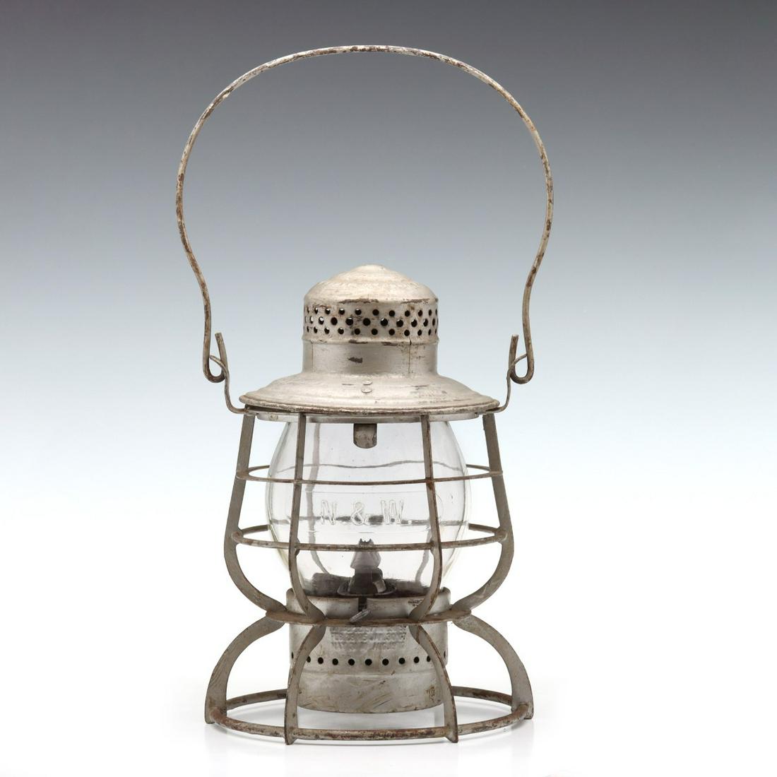 A TALL GLOBE RAILROAD LANTERN MARKED N. & W. RY: The wire frame with embossed maker's mark of ARMSPEAR MAN'F'G CO. NEW YORK and embossed railroad marking of N. & W. RY on the shoulder, tall extended lip glass globe with cast lettering of N . & W , w