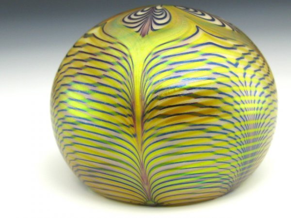 ORIENT & FLUME ART GLASS PAPERWEIGHT: Gold iridescent glass with pulled feather style lines and leaves, signed bottom and dated 1976.