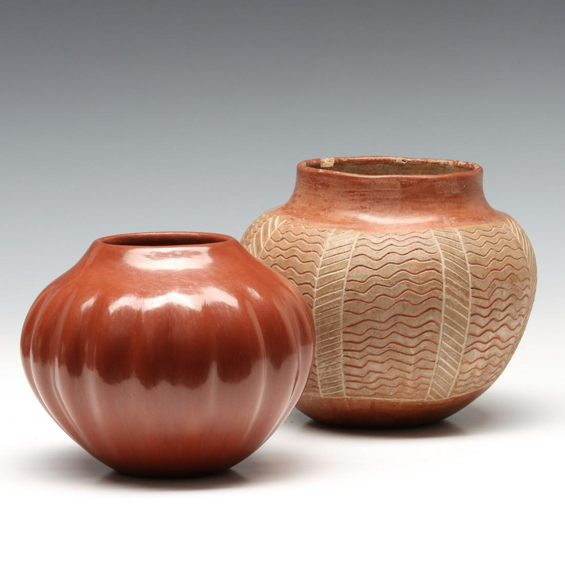 JEMEZ POTTERY VASE SIGNED JUANITA FRAGUA, PLUS ANOTHER: Late 20th Century. The polished red melon rib vase with scratched signature on the underside of the base, plus another vase with etched designs and damage at the rim. Measures 4.75 x 6.5 and 6 x 7.25 