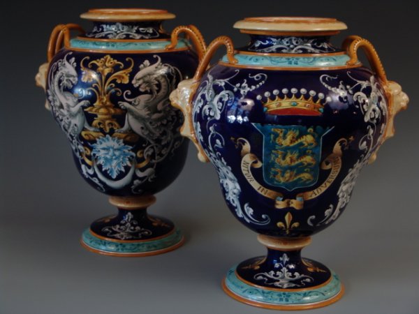 PAIR OF ULYSSE BLOIS COBALT BLUE FAIENCE VASE: Circa 1920's, matching pair of superb urn vases with deep cobalt blue background with three dragon crest, Latin motto "Nitor in Adversum" (I strive against opposition), fauns to sides, 15 inches tall