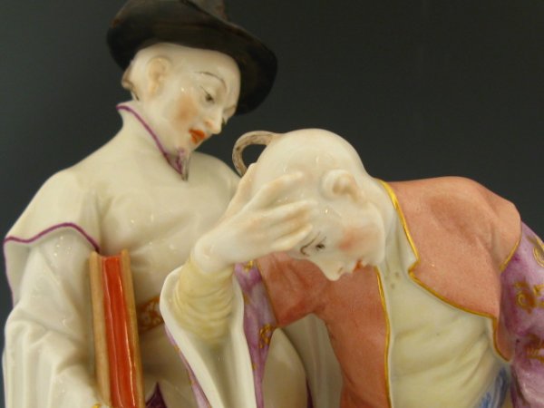NYMPHENBURG BUSTELLI CHINOISERIE GROUPING: Incised mark and number 375, this grouping represents a man humbly greeting a priest, both are after 18th century designs by Franz Anton Bustell that were originally produced singly and are now combin