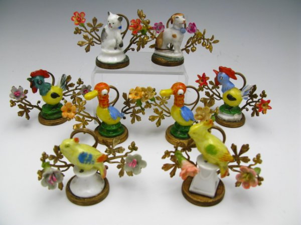 1920'S CHILDREN'S PARTY PLACE CARD HOLDERS: Eight porcelain figures on dore' metal mounts with porcelain flowers. Each base is marked MADE IN FRANCE.