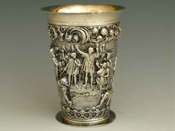 DEEP REPOUSSE' CONTINENTAL SILVER BEAKER: A highly detailed beaker with an incredibly high relief three-dimensional scene apparently of Columbus and the discovery of the New World. Measures 3 1/2" diameter and 4 3/4" tall, 266 g., no monogram