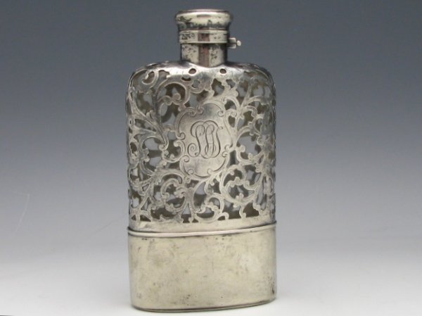 A GORHAM 1895 STERLING SILVER OVERLAY FLASK: An antique Lady's sterling silver overlay flask with the Gorham Co. date mark for 1895, measures 5 1/8"x 2 5/8", monogrammed.