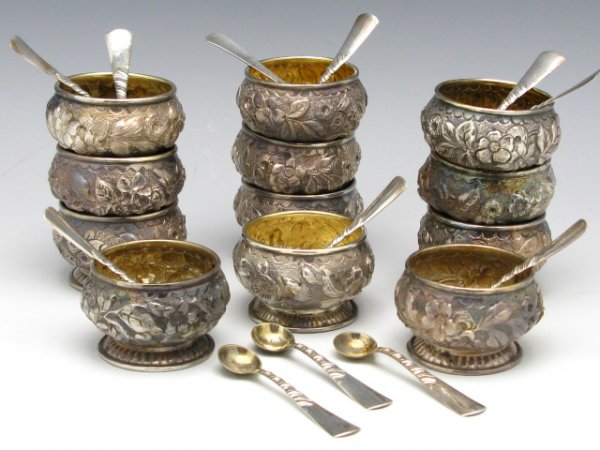 SET OF 12 REPROUSEE SALT CELLARS BY WHITING: Set of 12 reprousee salts by Whiting accompanied by 12 Gorham salt spoons, Each salt measures 1 1/8"x 1", each spoon is 2 1/16" long, total weight of 221 g., No monogram.